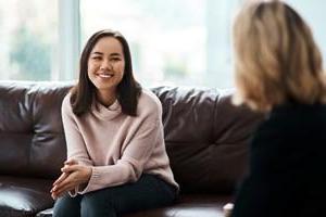 Smiling woman on couch during therapy